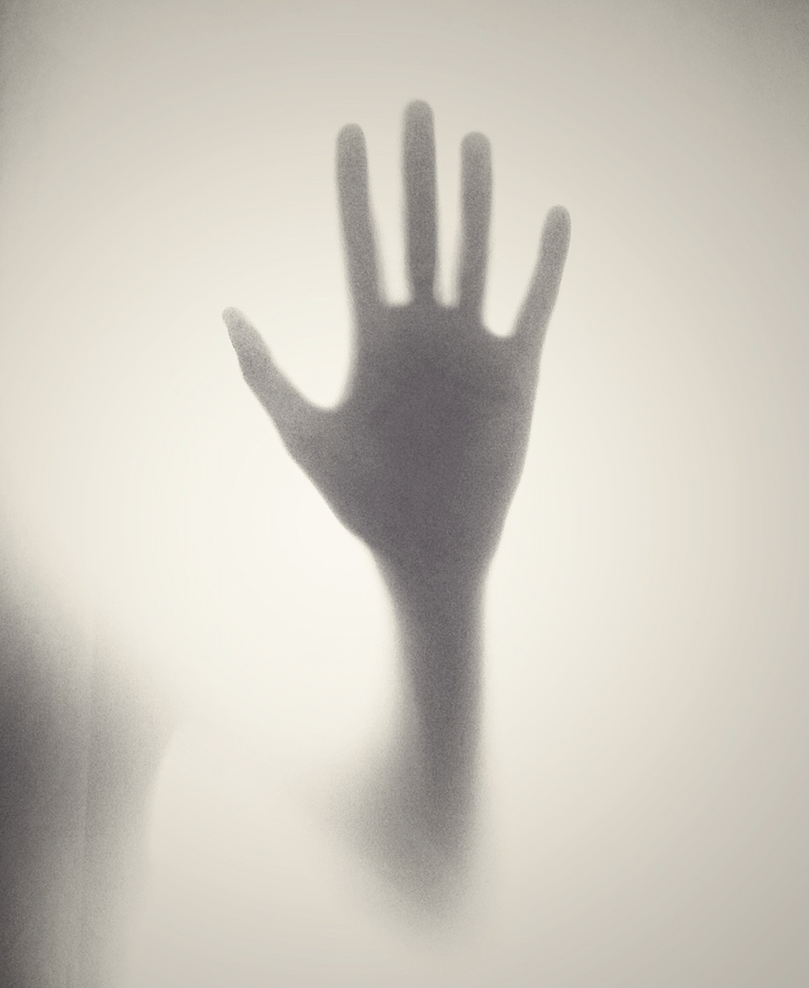 Shadow hand on glass