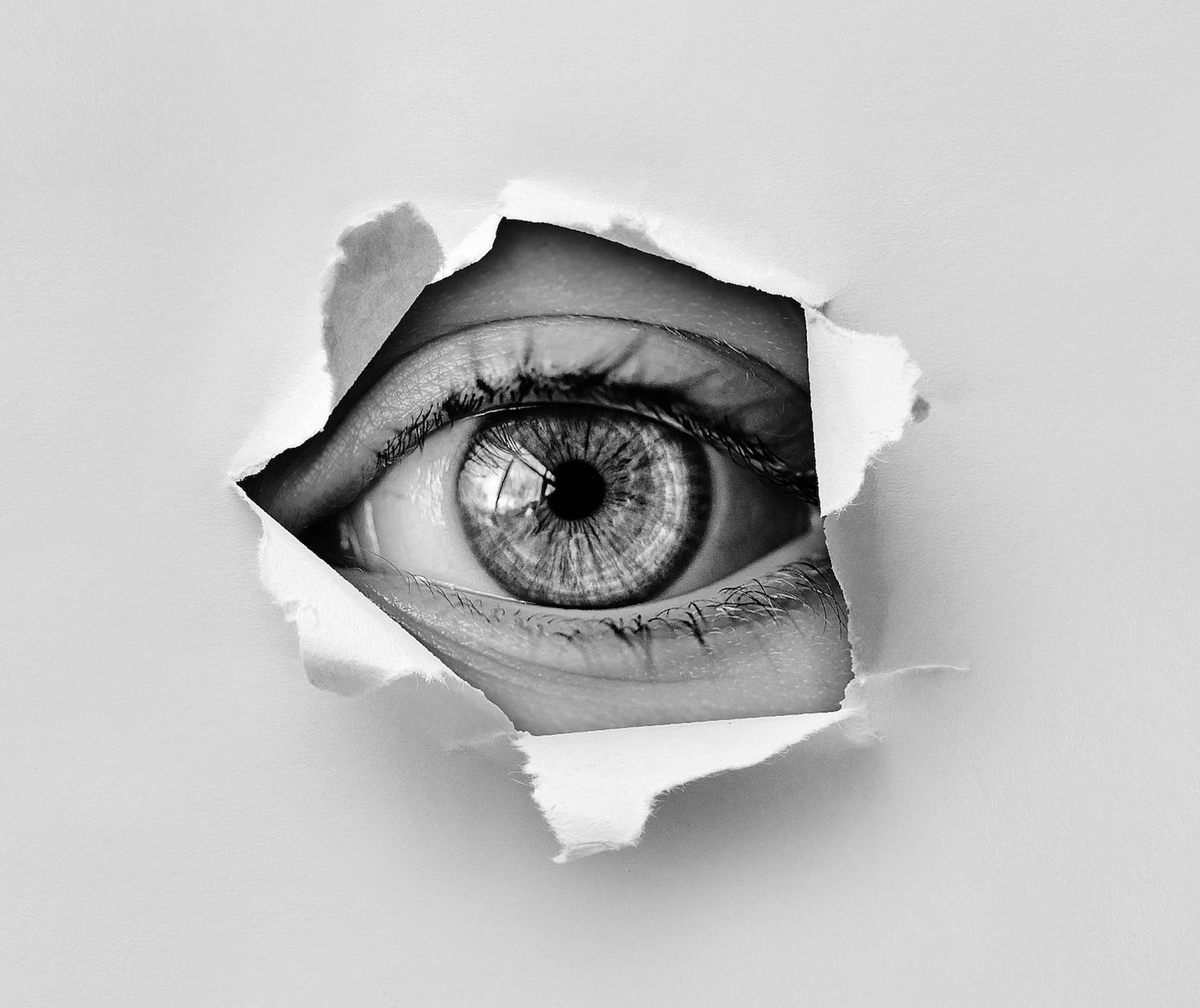 Eye peeking through paper